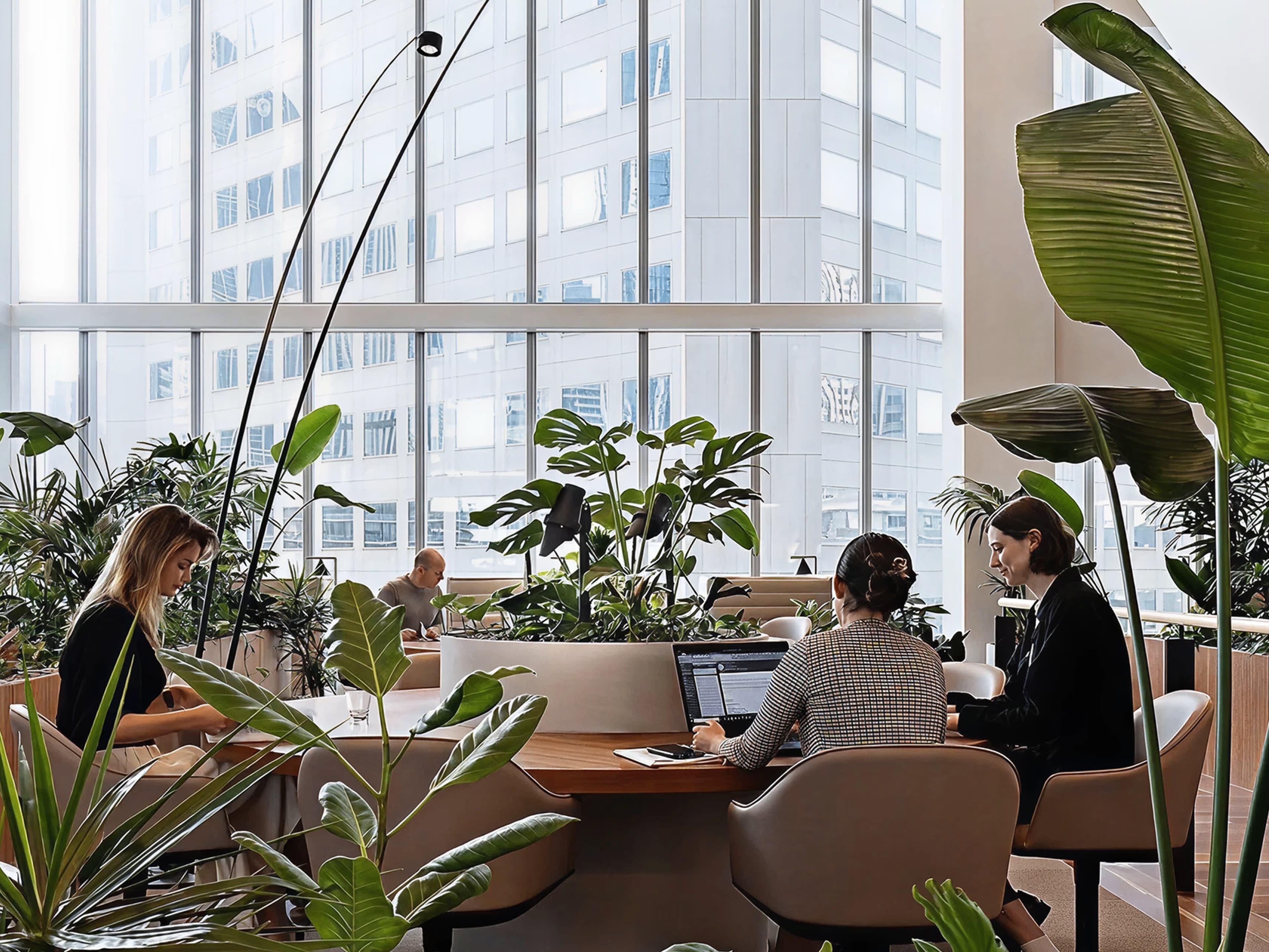 Creative professionals at work in a plant-filled office
