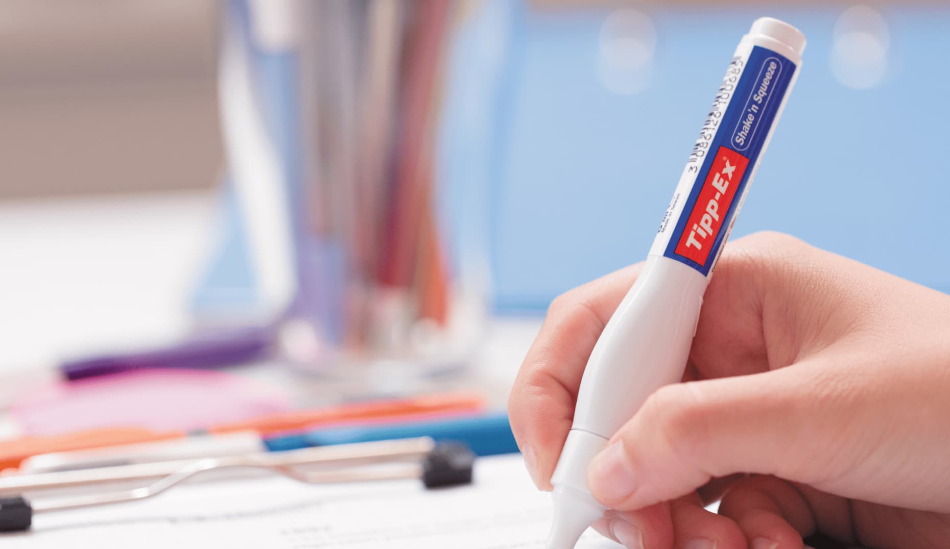 BIC — hand using a Tipp-Ex correction pen